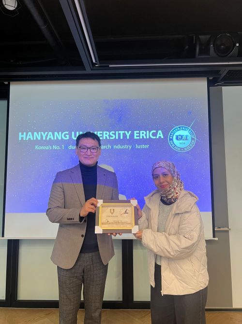 Penasihat Kelab Orator, Amy Zulaikha Mohd Ali, menyampaikan cenderahati kepada Dong Il Kim, Director of International Affairs, Hanyang University ERICA di Ansan sebagai tanda penghargaan atas kesudian menyambut delegasi Kelab Orator.
